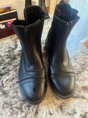 Women’s black horse back riding boots.